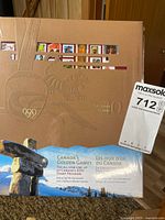 Front of sealed 2010 Olympic stamp collection album showing embossed design and inukshuk image