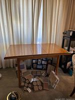 Full view of wooden dining table against curtains
