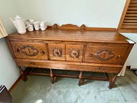 Front view showing full sideboard with drawers, doors, legs