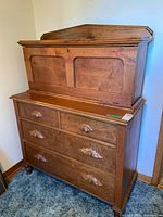 Full view of closed secretary desk with key in lock