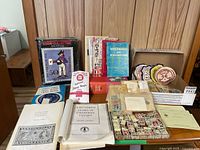 Overview of books, stamp album, loose stamps and booklets on table