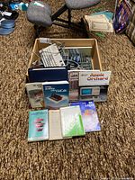 Box with Apple II hardware and manuals spread in front