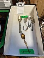 All six spoons in box labeled sterling and Coronation