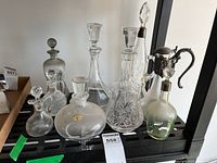 Group shot showing all eight decanters and cruets on shelf