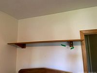 Full view of shelf mounted on wall above doorway