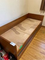 Overall view of wood daybed frame without mattress
