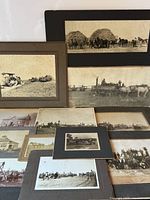 Group shot of all mounted photographs laid out showing quantity and variety