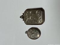 Front view of rectangular and oval engraved sterling lockets