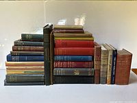 Entire lot arranged in two stacks showing quantity and range of spines