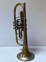 Full view of cornet standing upright showing overall form and bell