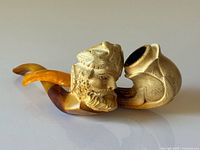 Full view of Bacchus carved meerschaum pipe with amber stem