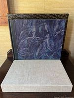 Album inside slipcase on display showing cover art and beige tray