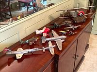 Overview of ten model aircraft on sideboard