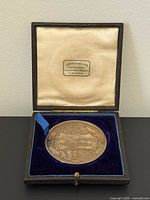Medal in open presentation case showing velvet interior and overall condition