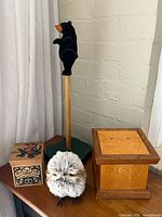 Group view of bear figure, owl, two cedar boxes