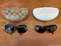 Closed Coach and Batali hard cases with sunglasses in front