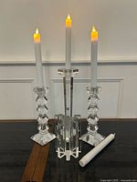 Three candlesticks with candles showing overall lot