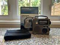 Radio, pouch and box on countertop