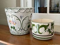 Front view of both planters showing decoration and size difference