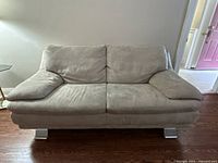 Front view of Italsofa beige ultrasuede loveseat showing overall design and condition
