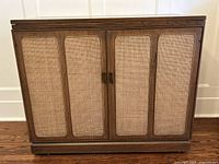 Front view of wood credenza with cane panels