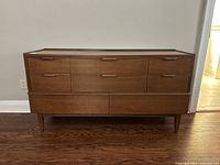 Front view of teak credenza showing eight drawers and integrated pulls
