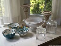 Group shot showing all items: three bowls, urn, two candle holders, two glass boxes