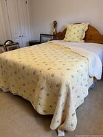 Quilt on bed showing overall size and colour