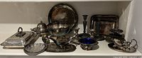 Overall view of all silver plated items on shelf