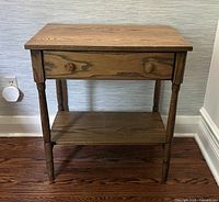 Front and top view of oak end table showing drawer and lower shelf