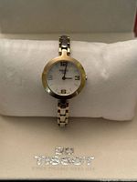 Front view of Tissot women’s watch on cushion inside box