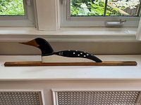 Full view of carved loon on wood bar