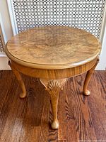Full view of round side table showing legs and overall design