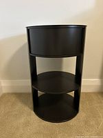 Front view of black metal round end table