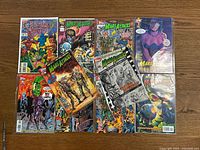 Full view of multiple Marvel comic books including Fantastic Four and several Mars Attacks comic issues arranged on wood floor.