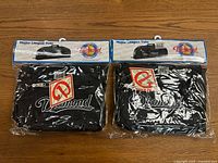 Pair of two black Diamond brand baseball/softball equipment bags sealed in original plastic packaging with header cards showing product image and branding.