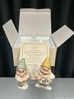 Pair of ceramic salt and pepper shakers modeled as Lenox dwarfs, Doc and Bashful, with certificate and box packaging visible