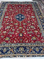 Full view of rug laid flat on floor, showing overall pattern, colors and size.
