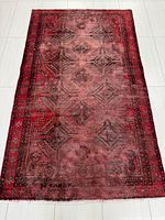 Full view of the Persian rug showing overall condition and pattern