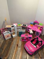 Overall view of all Barbie playset pieces and convertible car