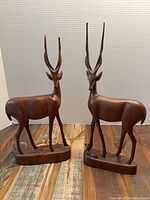 Both wooden antelope figures front view