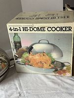 front of retail box showing product name and image of cooker