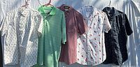 Five shirts hanging side by side showing fronts and patterns