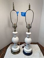 Full view of both hobnail milk glass lamps showing overall design and differing base finishes