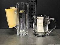 Both crystal tankards, Baccarat on left with wrapping sponge, Kosta on right with label