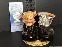 Front view showing kittens in boots, printed base text, and certificate of authenticity with edition number 487