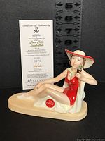 Front view of figurine with certificate showing edition number