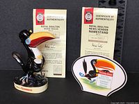 Both figurines front view with certificates