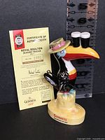 Figurine front view with certificate and ruler for scale
