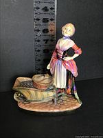 Front view of Molly Malone figurine with height ruler